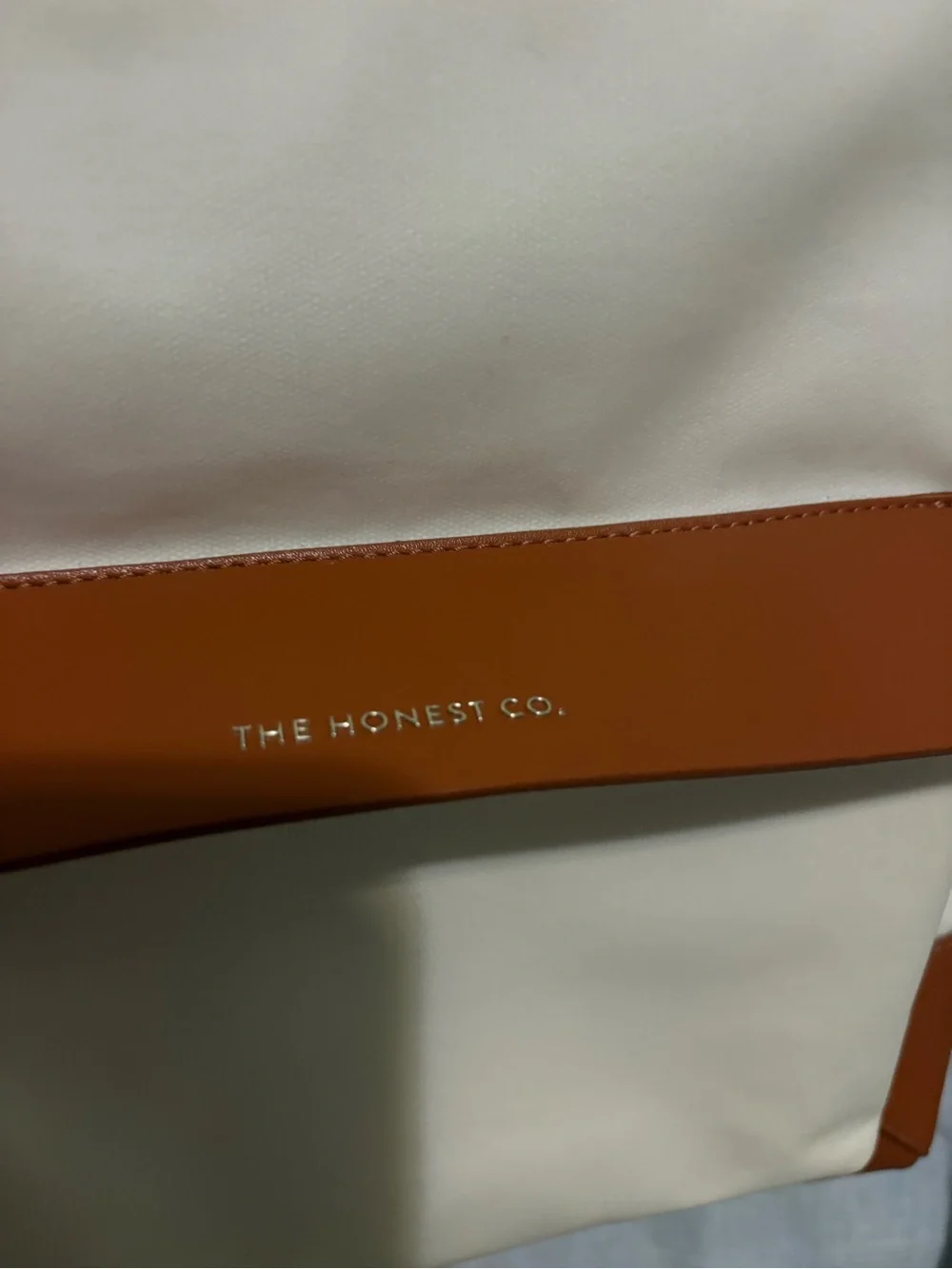 The Honest Company cream backpack